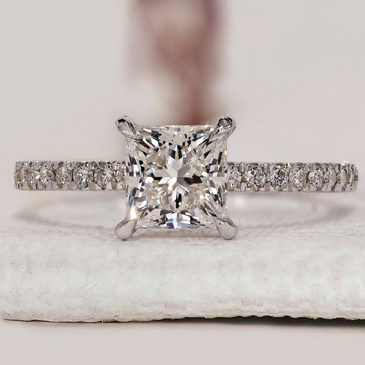 Princess diamond ring with round diamond pave set.
