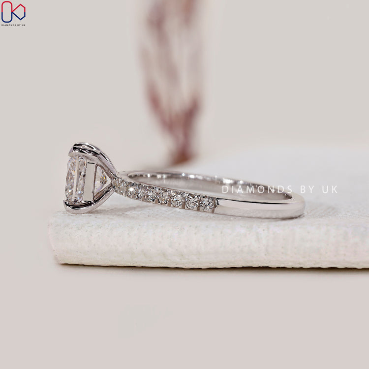 White gold ring with round pave and princess diamond.
