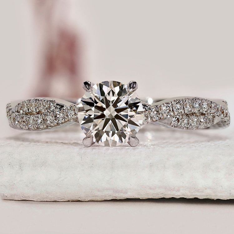 Round cut diamond ring with twisted pave set ring.

