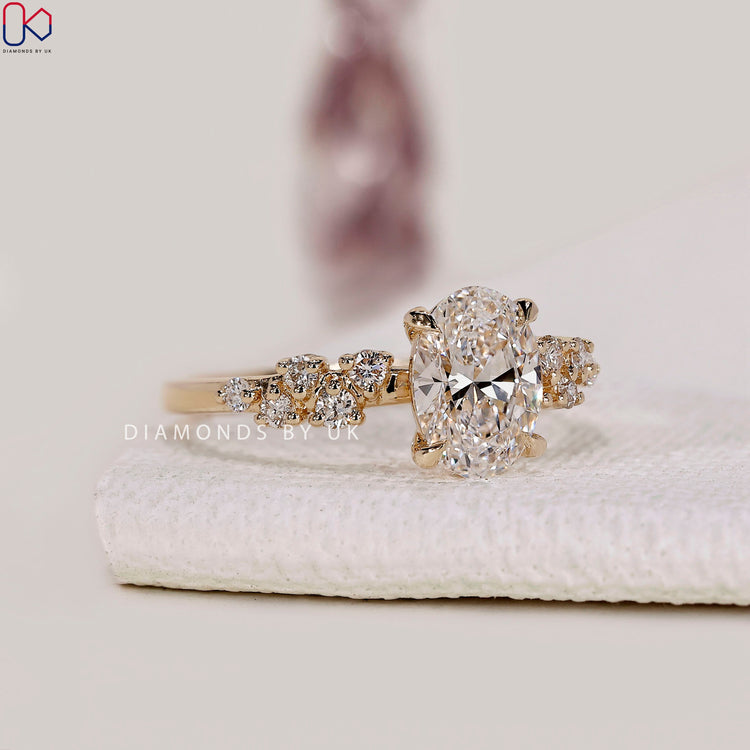 Yellow gold engagement ring with oval center stone.
