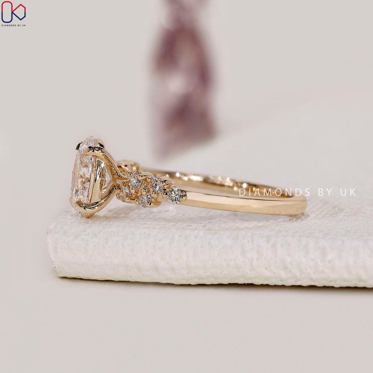 Lab grown diamond ring with oval cut and round accents.
