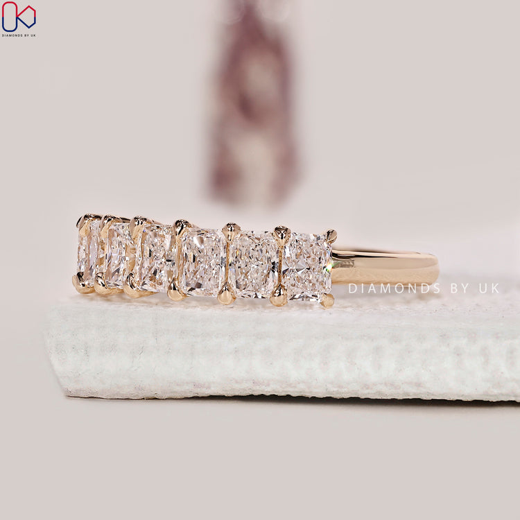 7 diamond wedding band featuring radiant cut diamonds arranged in a clean layout.
