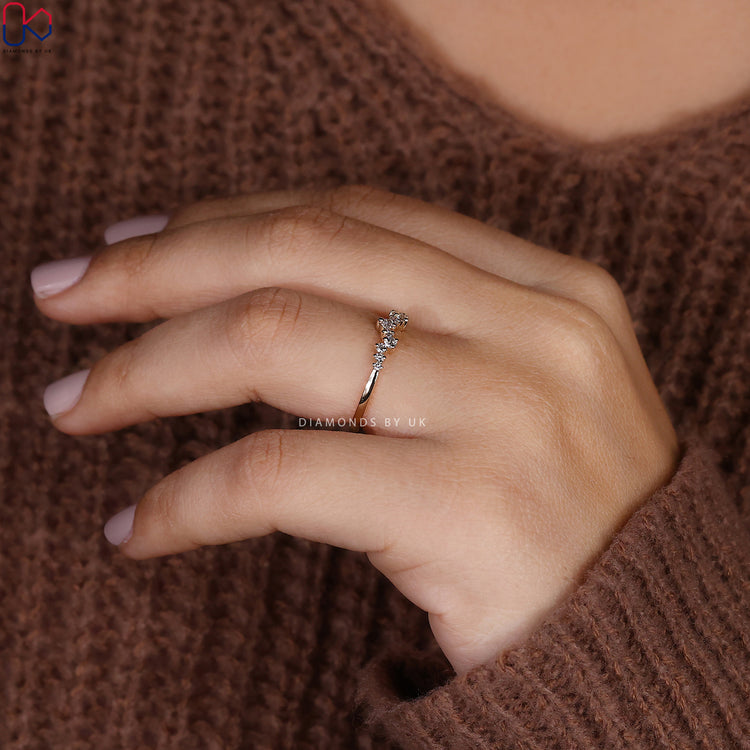 Prong set diamond band with lab grown stones arranged in a half eternity style.
