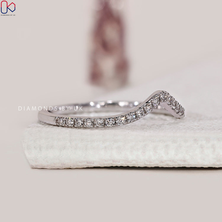 Half eternity wedding band with a unique chevron structure in white gold.
