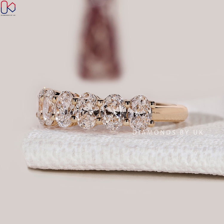 Handmade oval cut diamond band in half eternity style.
