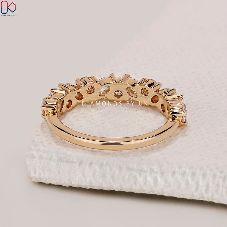 Marquise and round diamond wedding band designed in a secure prong set eternity style.
