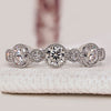 Round diamond half eternity wedding band with milgrain.
