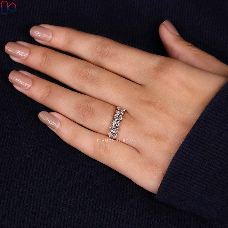 Minimalist wedding band designed with six oval diamonds for a subtle style.
