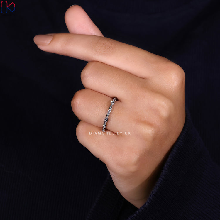 Round diamond and marquise band in half eternity style.