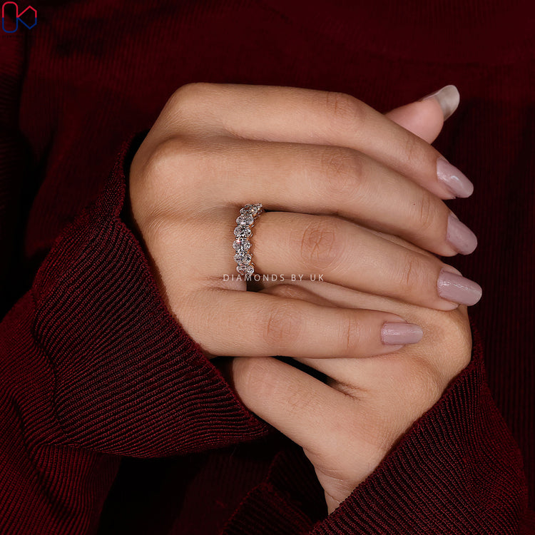 Oval cut diamond band by Diamondsbyuk with prongs.

