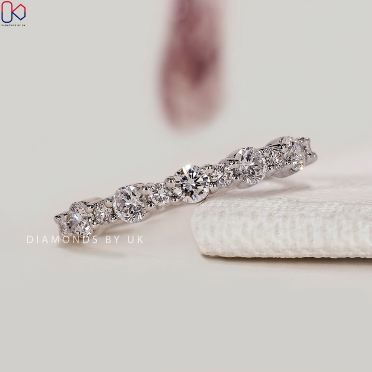 Round cut lab grown diamond band with prong setting.