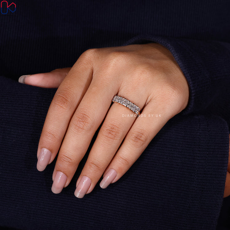 Anniversary gift her will adore—a yellow gold seven diamond radiant cut band.

