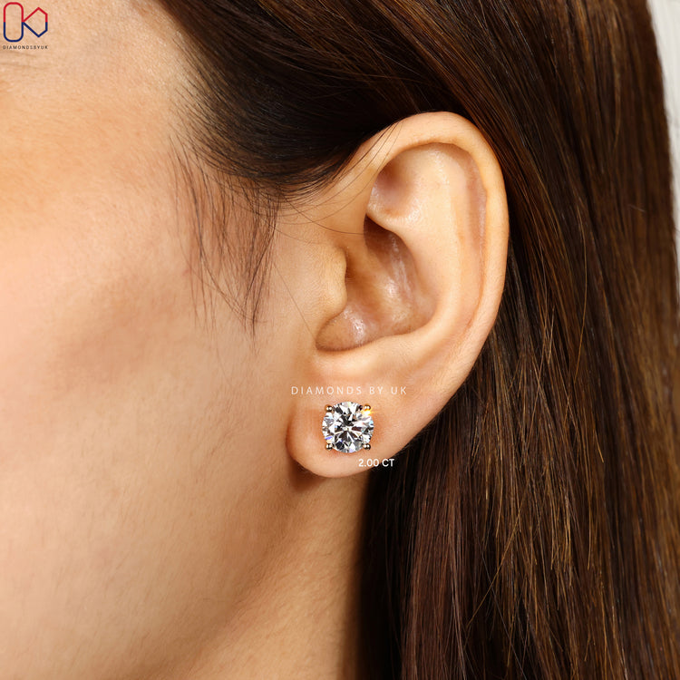 Round diamond stud earrings with push back closure.  