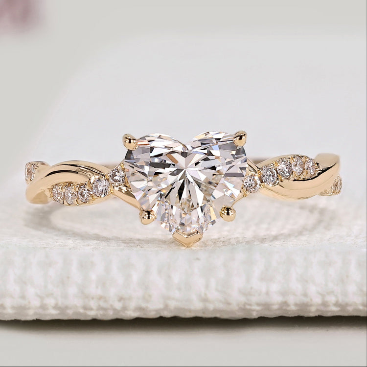 Heart cut diamond ring with twisted pavé style setting.
