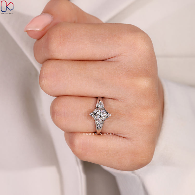 Three stone marquise ring with four claw setting.