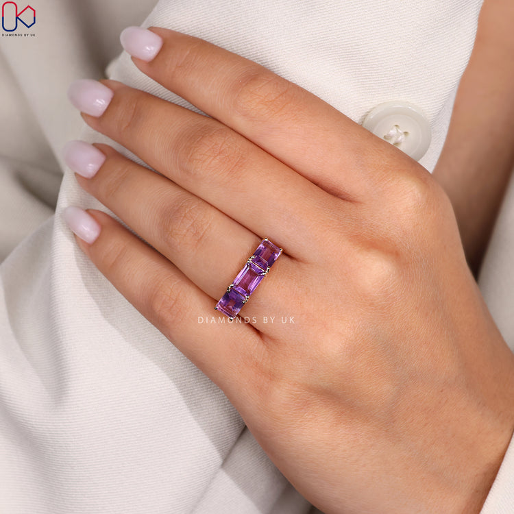 Emerald cut amethyst ring with white diamond side stones