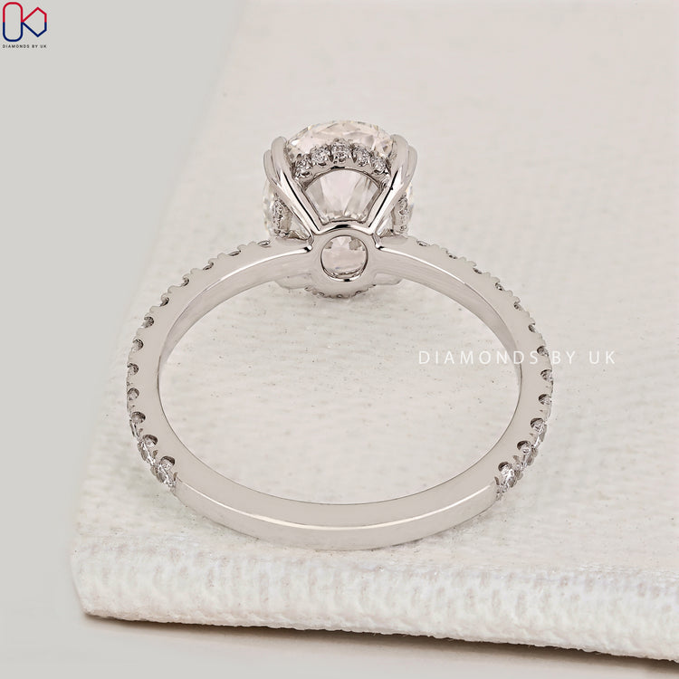 Handmade oval cut engagement ring with hidden halo.