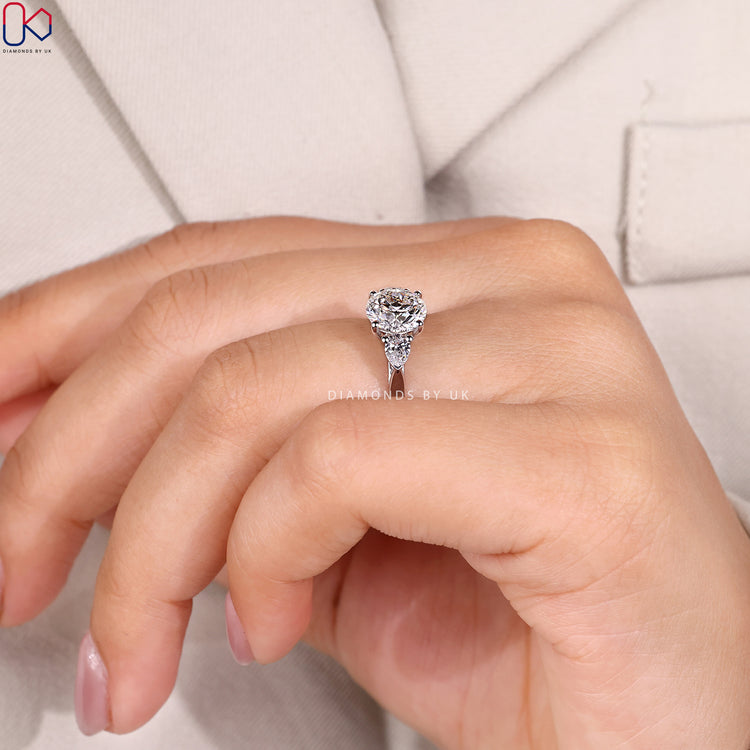 Lab grown round ring with pear side stones.