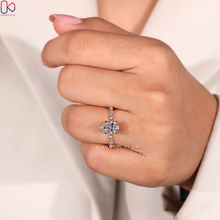 Shared prong pear ring with marquise diamond band.