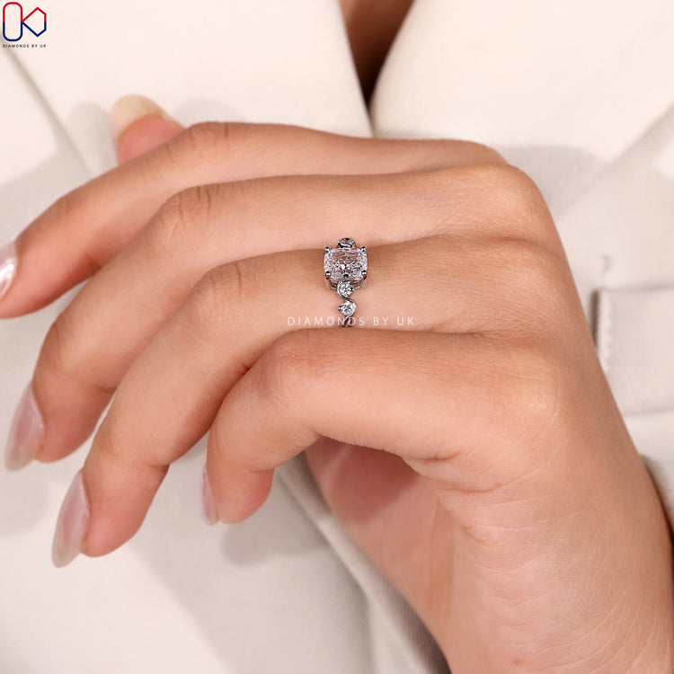 Lab grown cushion ring with round side stones.
