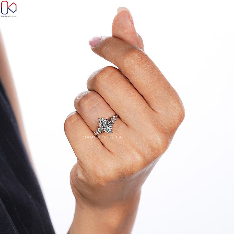Marquise cut diamond ring with round side stones.
