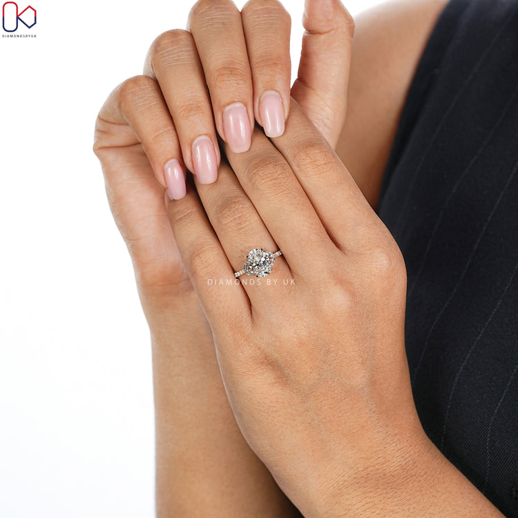 Diamondsbyuk oval diamond ring with round diamond pavé.
