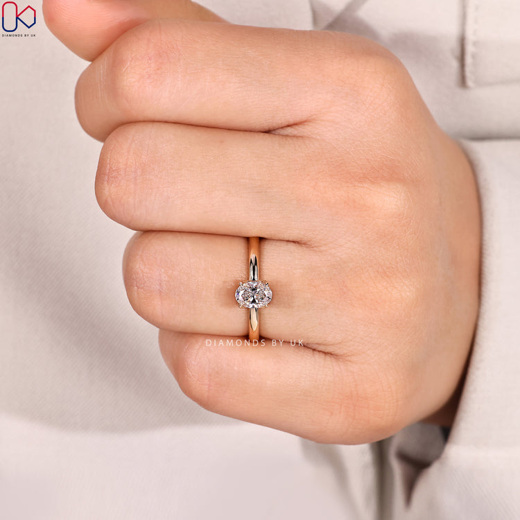 Four claw oval diamond ring with solitaire style.