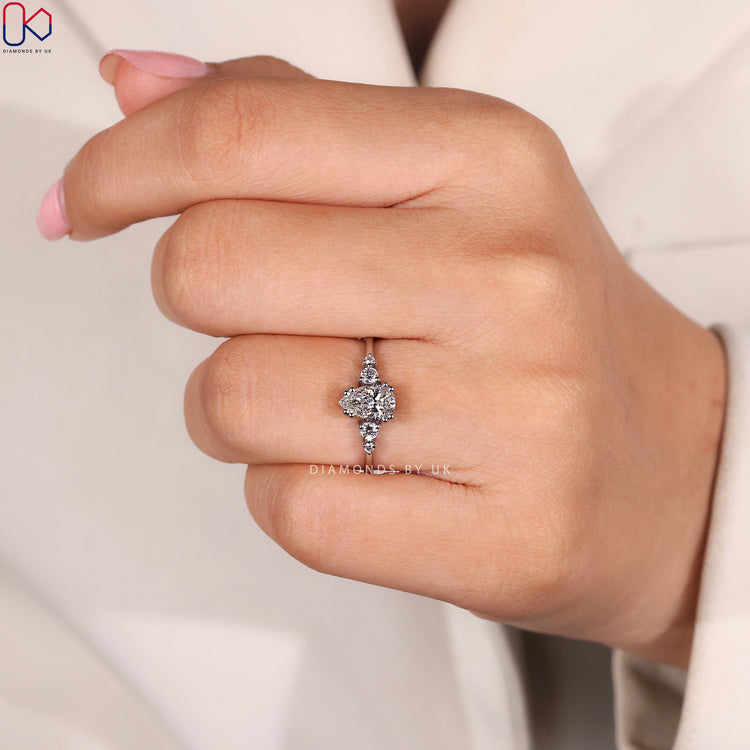 Muse setting pear cut ring with round diamonds.