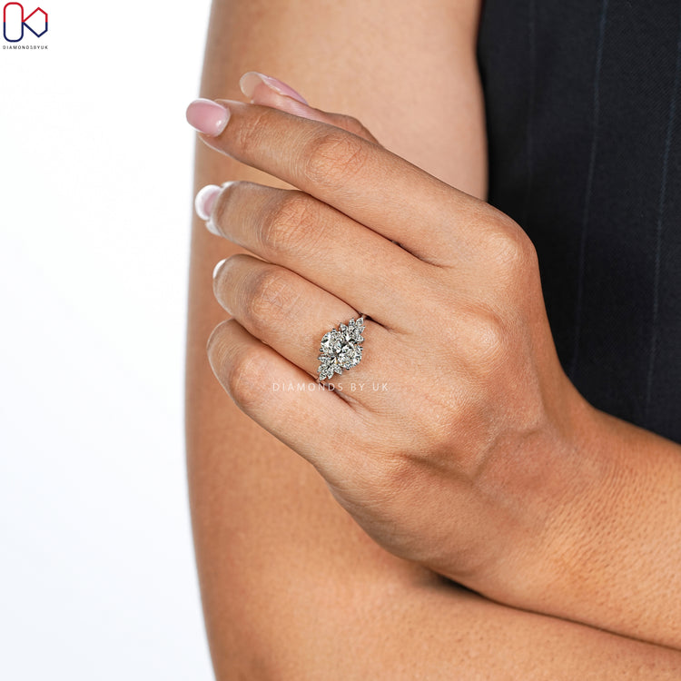 Lab grown oval engagement ring with marquise stones.
