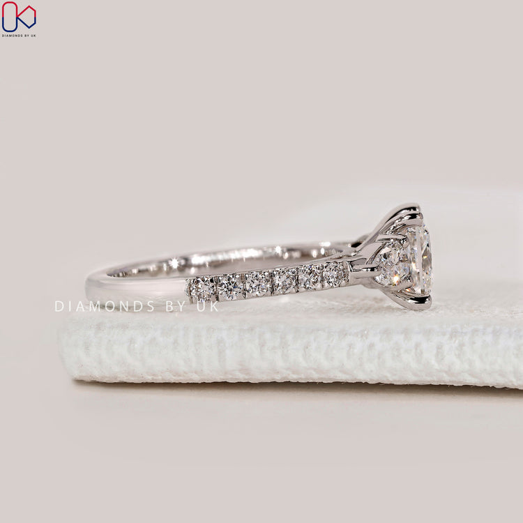 Lab grown princess cut ring with pear side stones.