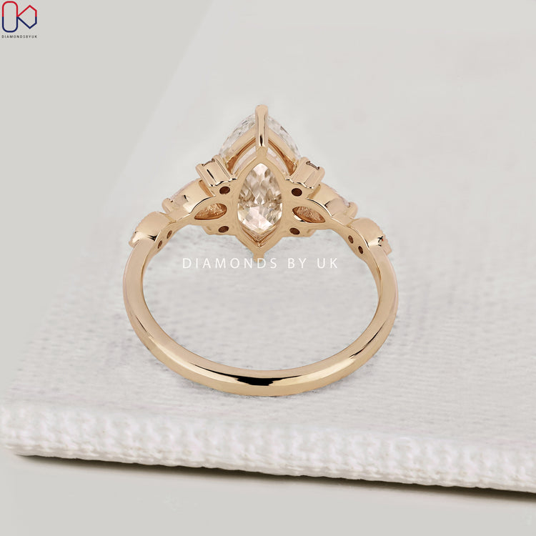 Lab grown marquise engagement ring with claw prongs.
