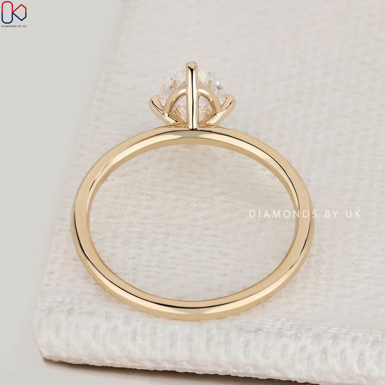Handmade oval cut ring with compass prong style.