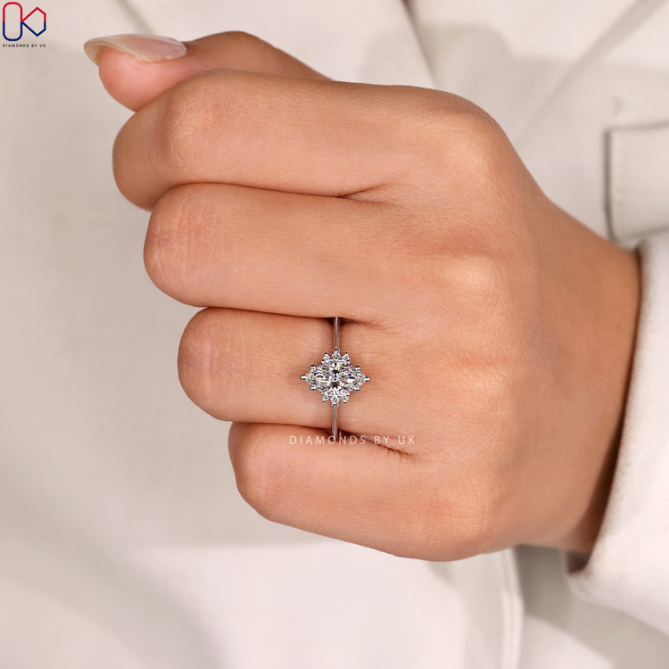 Muse setting marquise ring with round side stones.
