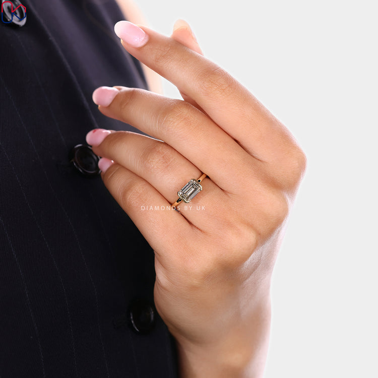 Emerald diamond ring with east to west setting

