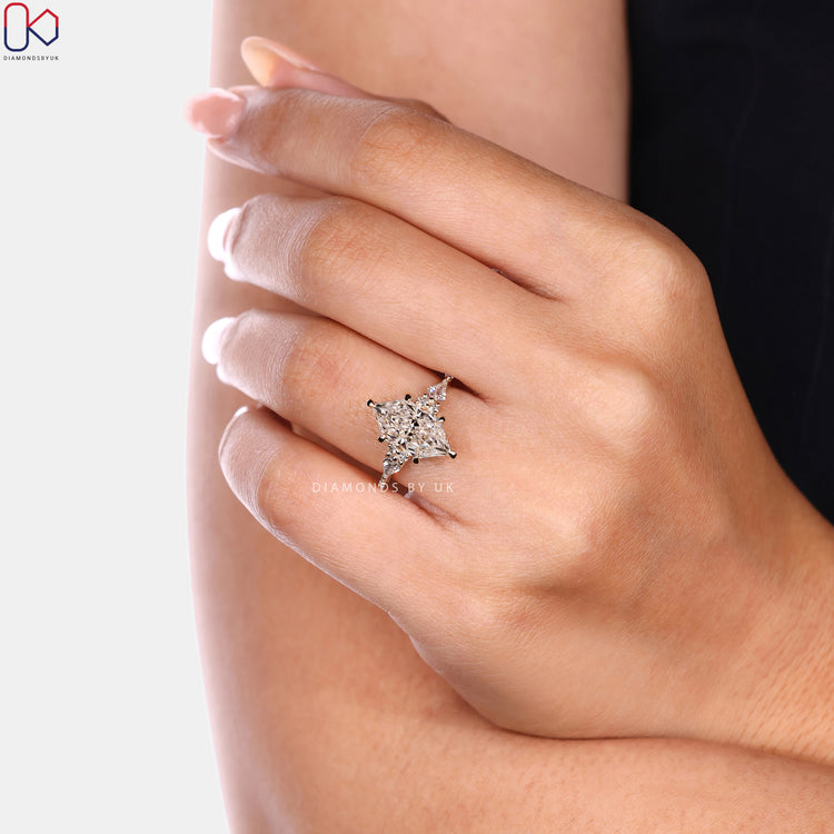 Dutch marquise ring with kite side stones and muse setting.  
