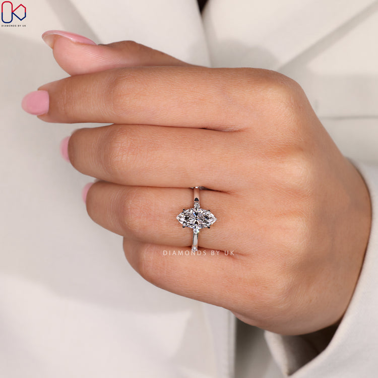 Marquise cut diamond ring with distance pavé setting.
