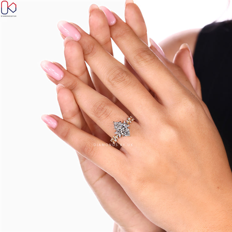Diamondsbyuk marquise diamond ring with cluster setting.
