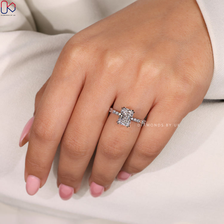 White gold engagement ring featuring a radiant cut diamond.
