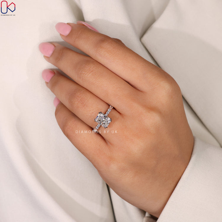 Handmade radiant cut engagement ring with a double claw prong.
