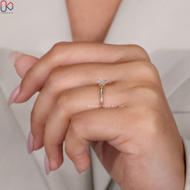 Yellow gold ring with an elegant oval diamond.
