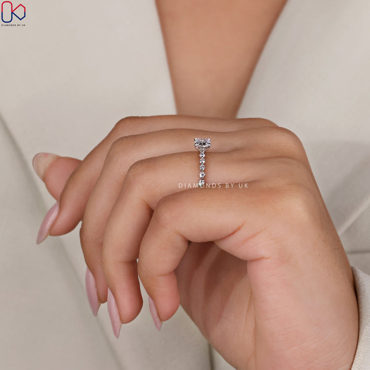 Handmade ring showcasing shared prongs and full circle cushion diamonds.