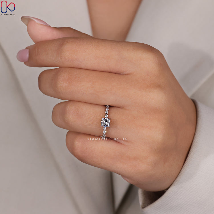 White gold ring made with shared prong cushion cut lab diamonds.
