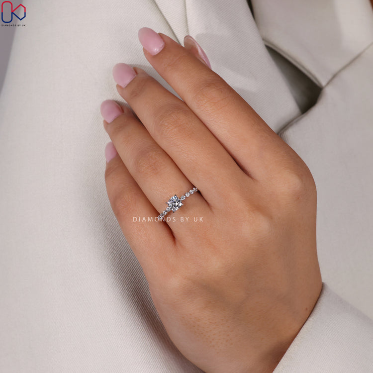 Cushion cut diamond ring featuring a shared prong setting in polished white gold.
