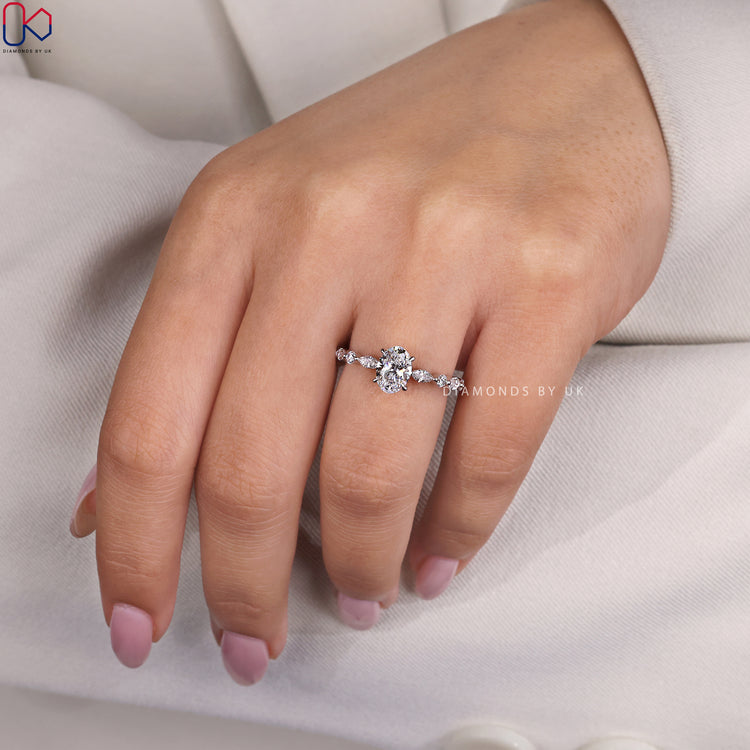 Oval diamond ring featuring a lab grown centre stone and detailed side accents.