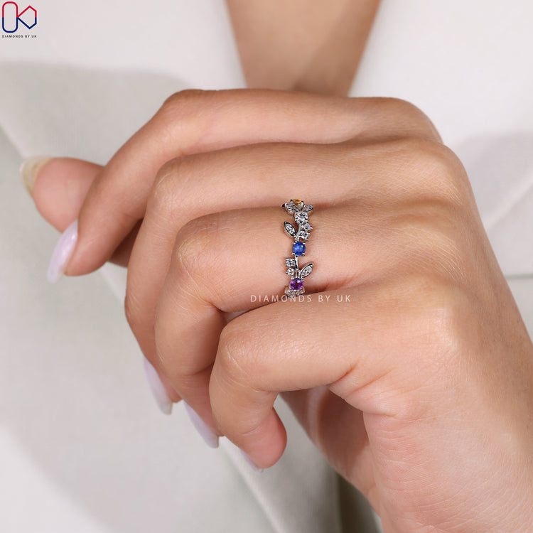 Buy diamond band with round diamonds and colored stones.
