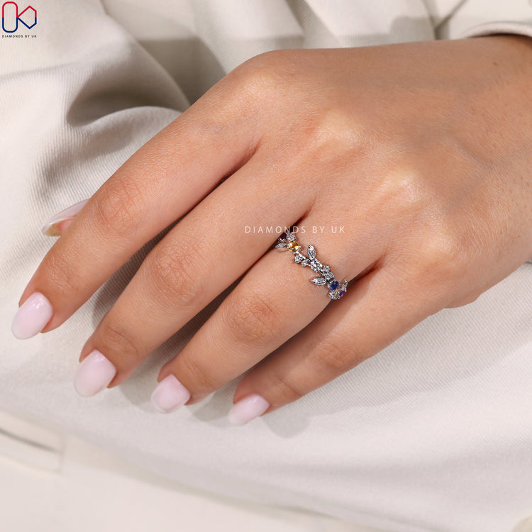 White gold wedding band featuring alexandrite diamond accents.
