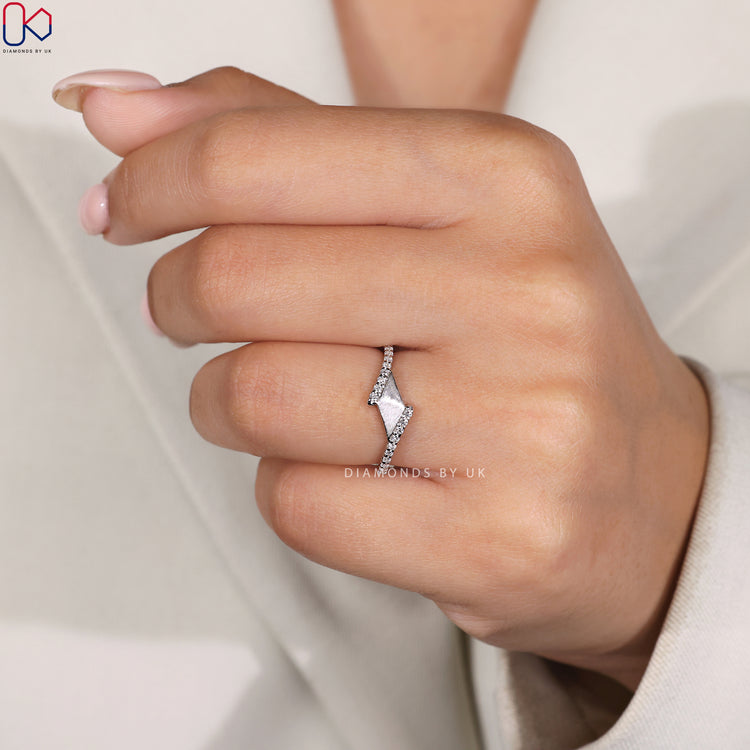 Prong set wedding band in white gold with a sleek matte texture.
