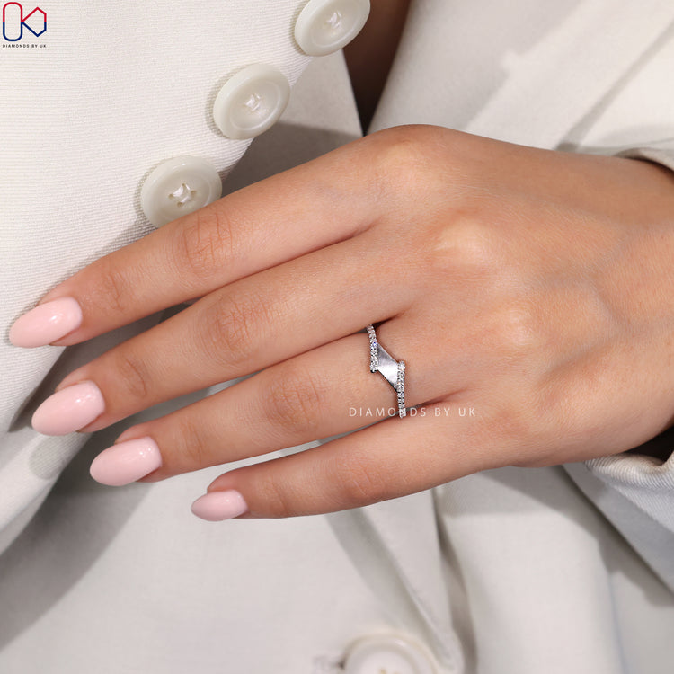 Custom wedding band featuring prong set round diamonds in white gold.

