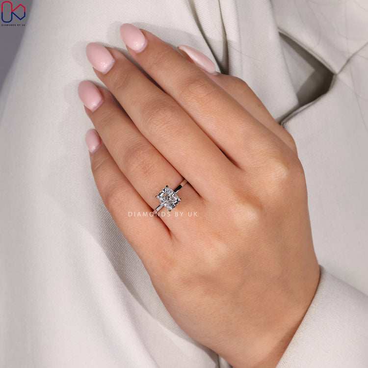 Cushion diamond ring with a 4 claw prong setting and lab grown diamond.