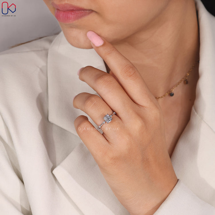 Distance pave engagement ring with cushion cut diamond.
